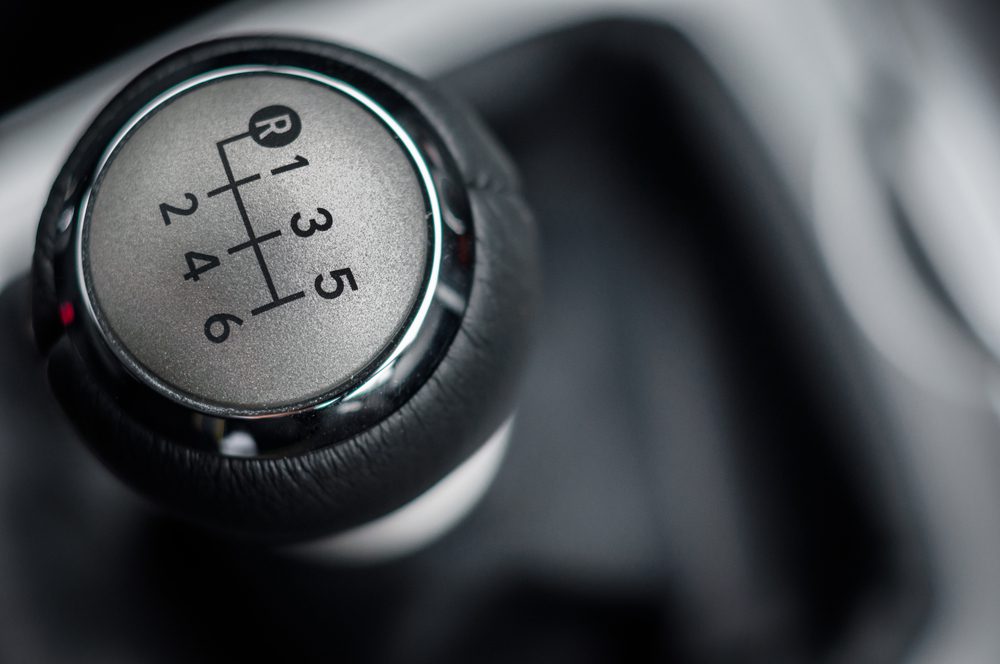 Manual gear knob in a car — choosing between automatic and manual licence