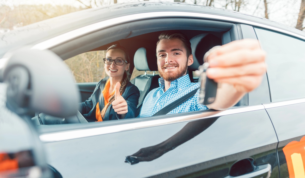 Happy learner driver holding car keys after passing driving test in Caboolture
